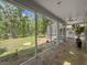 This screened-in back porch with tiled floor has views of the yard and adjoins a fenced spa area at 18308 Valor Path, Brooksville, FL 34604
