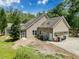 Exterior of a home with a screened in porch, a patio, mature landscaping and a long driveway at 18308 Valor Path, Brooksville, FL 34604