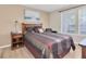 Comfortable bedroom with plush bedding, side tables, and natural light from a double window at 3260 Haviland Ct # 201, Palm Harbor, FL 34684