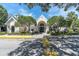 Exterior of a well-maintained community clubhouse with manicured landscaping at 3260 Haviland Ct # 201, Palm Harbor, FL 34684