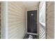 Condo exterior front door to unit 201 with neutral siding and a black door at 3260 Haviland Ct # 201, Palm Harbor, FL 34684