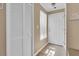 Inviting entryway with white door, tile floor, closet and window with natural light at 3260 Haviland Ct # 201, Palm Harbor, FL 34684