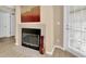 Living room fireplace with black trim, neutral tile and hearth with an adjacent outdoor patio door at 3260 Haviland Ct # 201, Palm Harbor, FL 34684