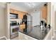 Galley kitchen features stainless steel appliances and stylish black granite countertops at 3260 Haviland Ct # 201, Palm Harbor, FL 34684