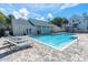 Community pool area with lounge chairs and a clubhouse in the background at 3260 Haviland Ct # 201, Palm Harbor, FL 34684