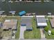 Aerial view of home situated next to a canal, with boats docked along the waterway and neighboring residences at 3362 Minnow Creek Dr, Hernando Beach, FL 34607