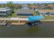 Aerial view of waterfront house with boat lift, boat dock, and canal access, highlighting outdoor living and recreational potential at 3362 Minnow Creek Dr, Hernando Beach, FL 34607
