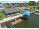 Aerial view of a waterfront home with a screened-in porch, boat dock, and canal access, showcasing outdoor amenities at 3362 Minnow Creek Dr, Hernando Beach, FL 34607