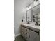 Modern bathroom featuring a double sink vanity with stone countertop, modern fixtures, and dark metal-framed mirrors at 3362 Minnow Creek Dr, Hernando Beach, FL 34607