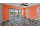 Bright bedroom with sliding glass doors to the lanai, ceiling fan, and view of the waterway at 3362 Minnow Creek Dr, Hernando Beach, FL 34607