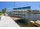 Waterfront property featuring a boat dock and lift on a canal, perfect for boating enthusiasts with easy water access at 3362 Minnow Creek Dr, Hernando Beach, FL 34607