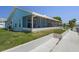 Waterfront home featuring a screened porch, well-maintained lawn, and concrete seawall, offering a relaxing outdoor living space at 3362 Minnow Creek Dr, Hernando Beach, FL 34607