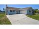 Well-kept single-Gathering home featuring an attached garage, chimney, and a spacious concrete driveway at 3362 Minnow Creek Dr, Hernando Beach, FL 34607