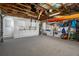 Spacious garage featuring epoxy flooring, overhead storage, and white wall-mounted cabinets for a clean, organized space at 3362 Minnow Creek Dr, Hernando Beach, FL 34607