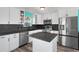 Beautifully remodeled kitchen featuring stainless appliances, light cabinets, and a functional center island at 3362 Minnow Creek Dr, Hernando Beach, FL 34607