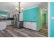 Well-lit kitchen and dining area with a modern chandelier and stainless steel refrigerator at 3362 Minnow Creek Dr, Hernando Beach, FL 34607