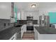 Updated kitchen featuring stainless appliances, gray countertops, white cabinetry, and hardwood flooring at 3362 Minnow Creek Dr, Hernando Beach, FL 34607