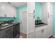 Convenient laundry room with modern washer and dryer, ample storage, and a utility sink at 3362 Minnow Creek Dr, Hernando Beach, FL 34607
