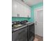 Laundry room with washer, dryer, white cabinets for storage, and a door leading outside at 3362 Minnow Creek Dr, Hernando Beach, FL 34607