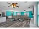 Spacious living room with wood-look floors, ample seating, modern fireplace, and flat screen TV at 3362 Minnow Creek Dr, Hernando Beach, FL 34607