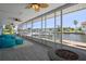 Screened porch with waterfront views, comfortable seating, ceiling fans, and a decorative rug and a modern fire pit at 3362 Minnow Creek Dr, Hernando Beach, FL 34607