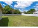 Expansive backyard featuring a well-maintained lawn, a privacy fence, and ample space for recreation at 37623 Florida Ave, Dade City, FL 33525
