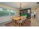 Inviting dining room featuring a wooden table, chandelier, and a decorative green sideboard at 37623 Florida Ave, Dade City, FL 33525