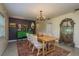 Stylish dining area showcasing a rustic wooden table, decorative mirror, and an elegant chandelier at 37623 Florida Ave, Dade City, FL 33525