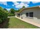 Exterior view of a well-maintained home, showcasing a tidy lawn, trimmed hedges, and a gravel walkway at 37623 Florida Ave, Dade City, FL 33525