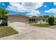 Spacious home with an attached garage, long driveway and attractive landscaping enhancing its curb appeal at 37623 Florida Ave, Dade City, FL 33525