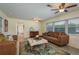 Inviting living room featuring a patterned rug, comfortable sofas, and bright natural light at 37623 Florida Ave, Dade City, FL 33525