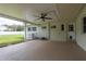 Spacious covered patio with a ceiling fan, offering an ideal outdoor space for relaxation and entertaining at 37623 Florida Ave, Dade City, FL 33525