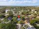 Aerial view of the home nestled amongst lush greenery in a residential neighborhood at 417 Inness Dr, Tarpon Springs, FL 34689