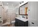 Charming bathroom features a stylish vanity with a dark cabinet, white countertop, and tiled shower with glass blocks at 417 Inness Dr, Tarpon Springs, FL 34689