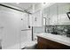 Bright bathroom with glass-enclosed shower, white cabinets, and modern vanity with stylish backsplash at 417 Inness Dr, Tarpon Springs, FL 34689