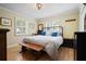 Cozy bedroom with wood floors, shuttered windows, and a comfortable bed with blue pillows at 417 Inness Dr, Tarpon Springs, FL 34689