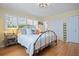 Bedroom featuring hardwood floors, bright lighting, closet, and two windows with views at 417 Inness Dr, Tarpon Springs, FL 34689