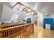Upper bonus room with sloped ceilings, hardwood floors, multiple seating and storage areas at 417 Inness Dr, Tarpon Springs, FL 34689