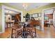 Dining area with wooden table, hardwood floors, views to kitchen, staircase and formal dining room at 417 Inness Dr, Tarpon Springs, FL 34689