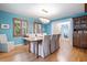 Dining room boasts a chandelier, hardwood floors, and built-in wooden cabinet at 417 Inness Dr, Tarpon Springs, FL 34689