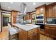 Kitchen featuring a large island with granite countertops, stainless steel appliances, and custom cabinetry at 417 Inness Dr, Tarpon Springs, FL 34689