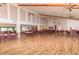 View of the spacious clubhouse hall with vaulted ceilings, ceiling fans, and a wooden dance floor at 4647 Gazebo Ct, New Port Richey, FL 34655