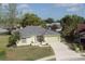 Well-maintained single-Gathering home featuring a manicured lawn, mature trees, and a two-car garage at 4647 Gazebo Ct, New Port Richey, FL 34655