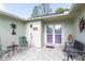 Inviting covered front porch with chairs, perfect for relaxing and enjoying the outdoors at 4647 Gazebo Ct, New Port Richey, FL 34655
