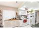 Well-lit kitchen with stainless steel appliances, white cabinets, and practical countertop space at 4647 Gazebo Ct, New Port Richey, FL 34655