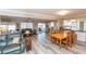 Open-concept living room with wood floors and comfortable seating that leads to the kitchen at 4647 Gazebo Ct, New Port Richey, FL 34655