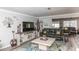 Spacious living room featuring modern flooring, a large TV, and comfortable seating at 4647 Gazebo Ct, New Port Richey, FL 34655