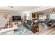 Inviting living room with wood flooring, a large TV, comfortable furniture, and stylish decor at 4647 Gazebo Ct, New Port Richey, FL 34655