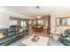 Spacious open-concept living room with wood floors, comfortable seating, and seamless flow at 4647 Gazebo Ct, New Port Richey, FL 34655