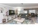 Spacious living room featuring modern flooring, a large TV, and comfortable seating at 4647 Gazebo Ct, New Port Richey, FL 34655